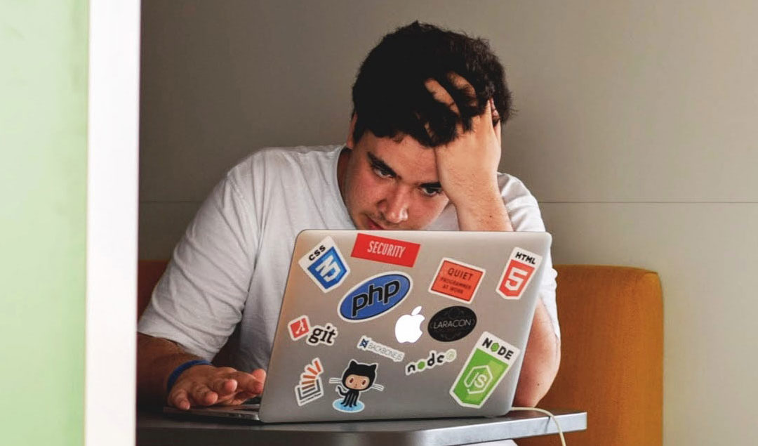 Frustrated person using a laptop
